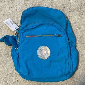 Kipling book bag with rainbow zippers.
